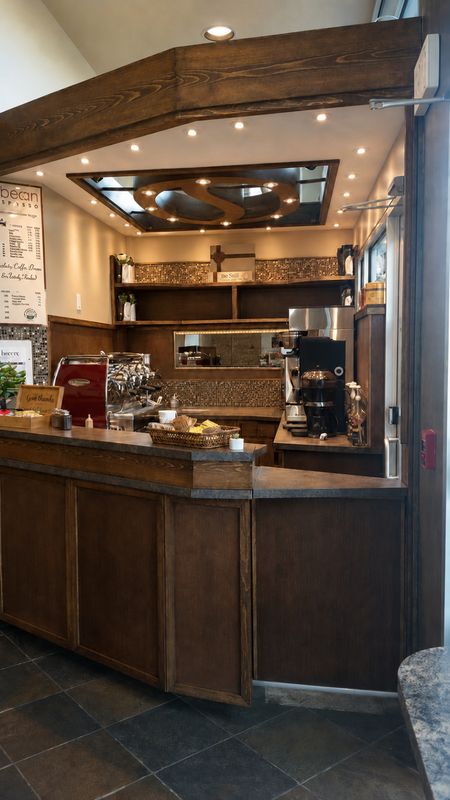 Finished commercial coffee bar with custom wood cabinetry and espresso station