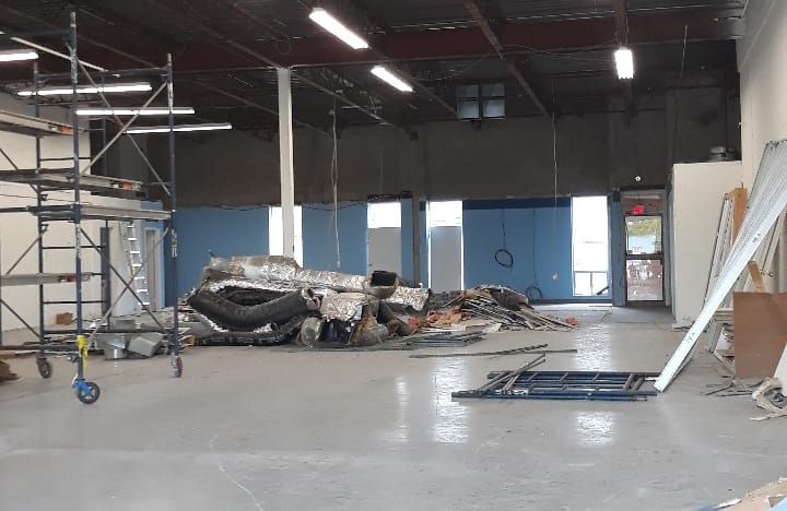 Warehouse leasehold space before renovation - raw concrete and debris