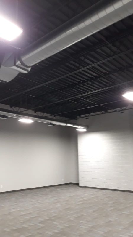 Finished warehouse interior with painted block wall and new flooring